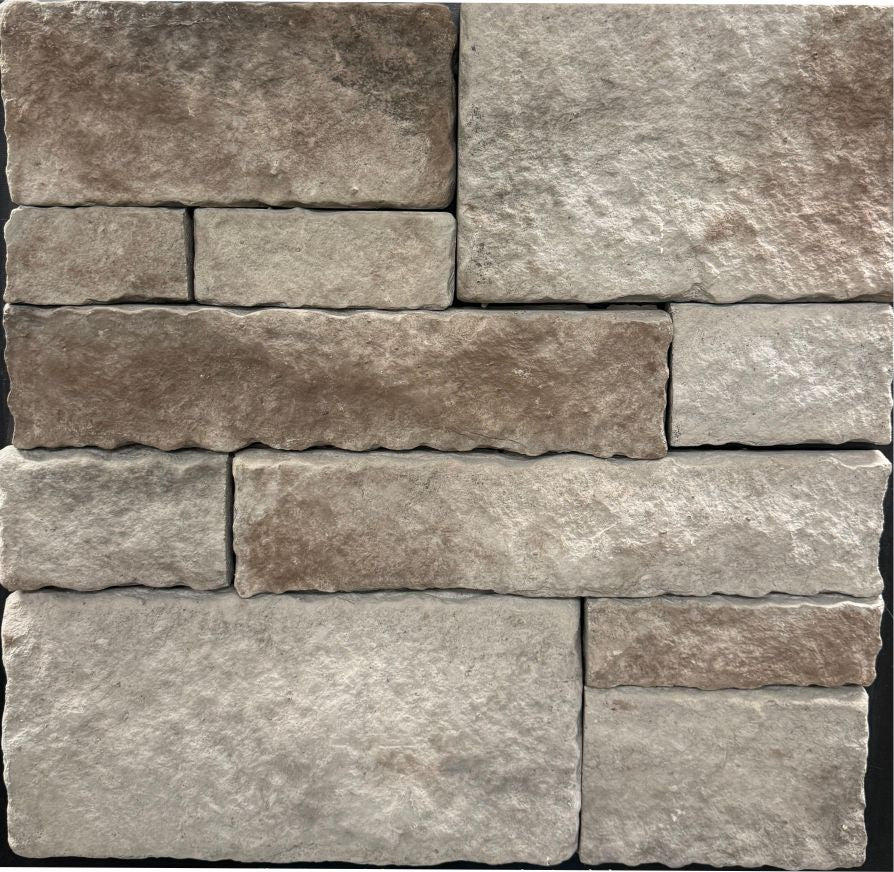 Ashlar – Fargo Brown sample board. Cream, brown and taupe blocks with tumbled edges, shown with a gray mortar joint.
