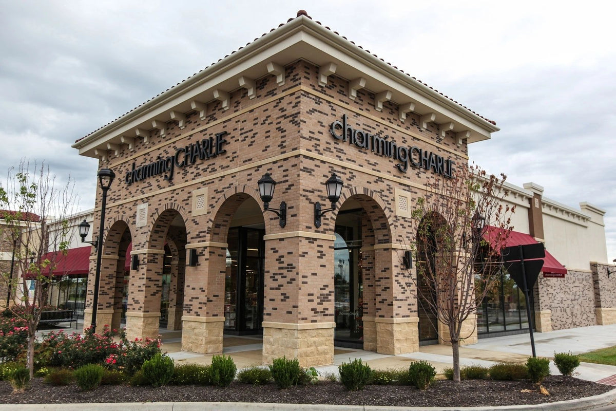 Retail storefront with arched stone veneer columns by Stone Mountain Manufacturing, Kansas City