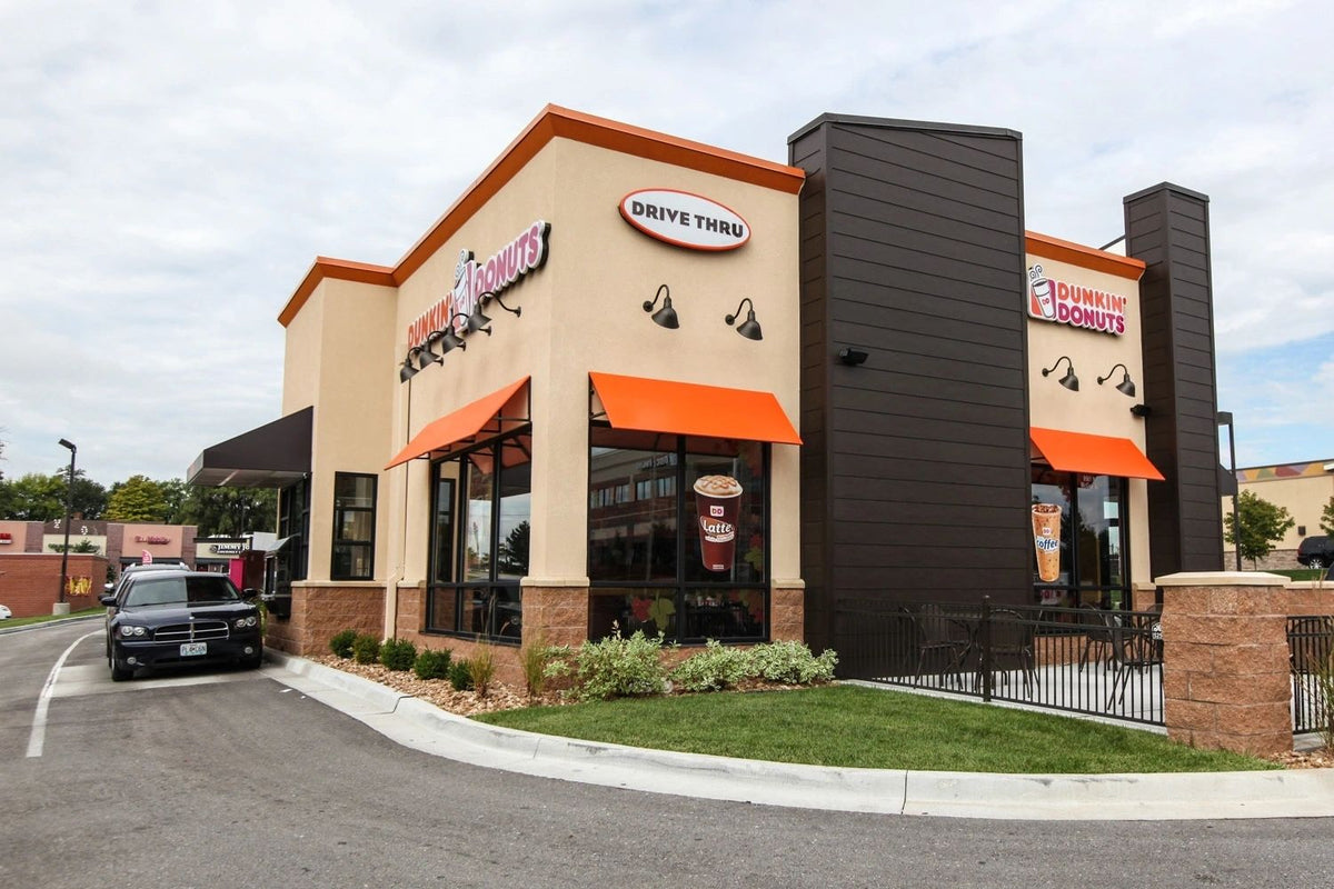 Dunkin' Donuts drive-thru with a tan stone veneer base and pillars, Kansas City area