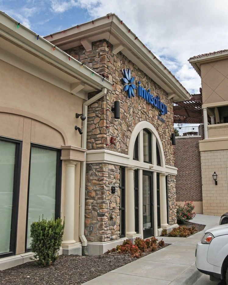 Retail entry with stone veneer arch and pilasters, Kansas City area