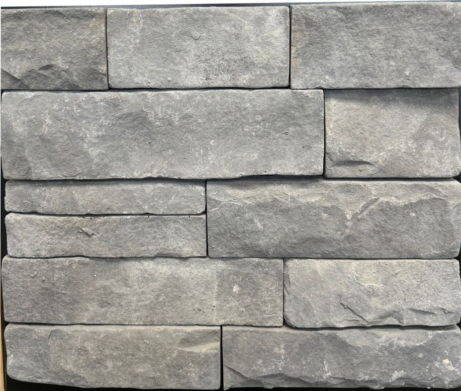 Ledge – Charcoal sample board. Medium gray ledge pieces with a split face and tight joints.