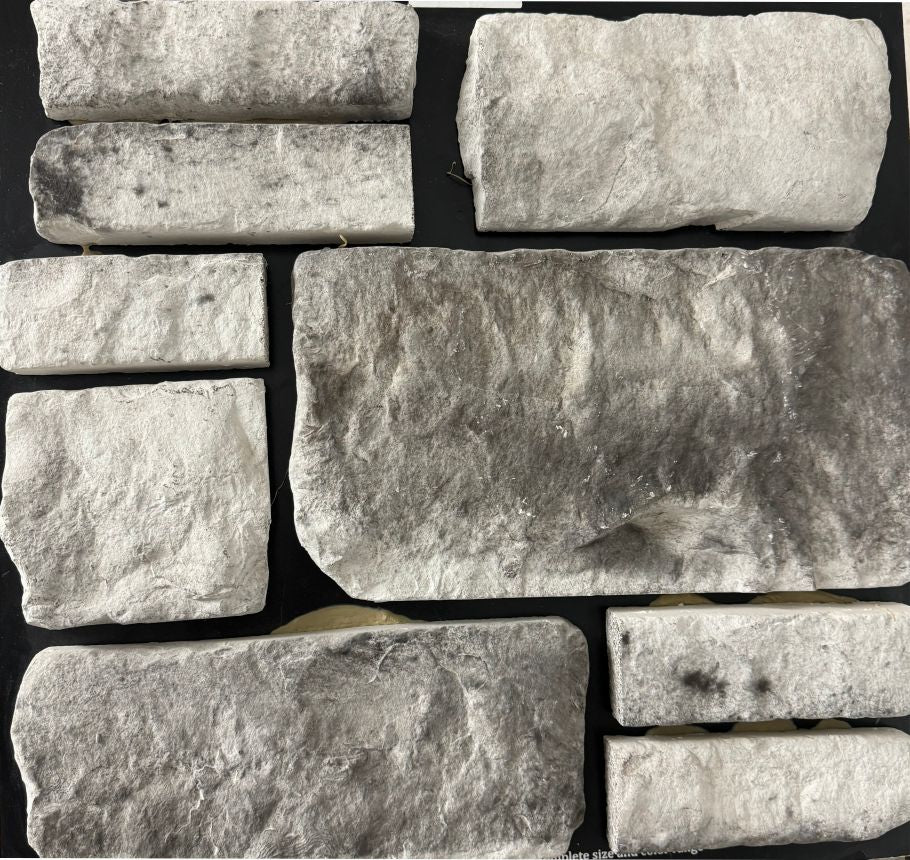 Tumbled – Snow Charcoal sample board. White pieces with charcoal shading and softened edges.