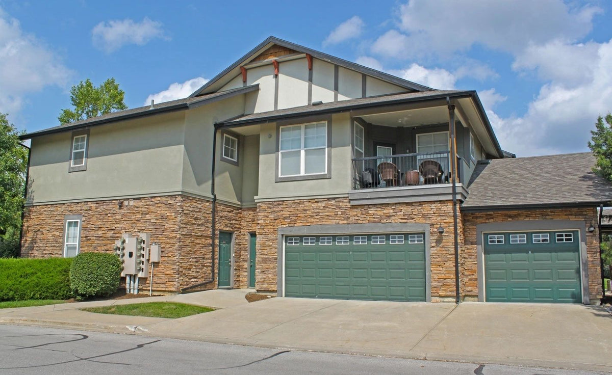 Home with thin brick veneer and stone accents around the garage, Kansas City area
