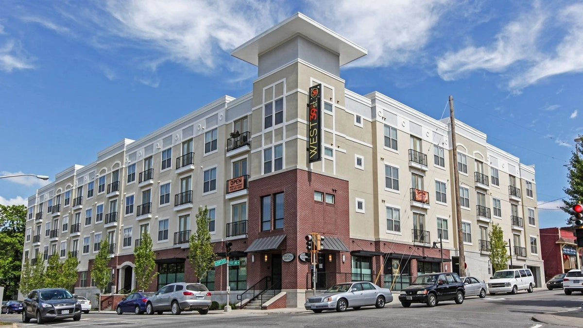 Five-story mixed-use building with a thin brick and stone veneer base, Kansas City area