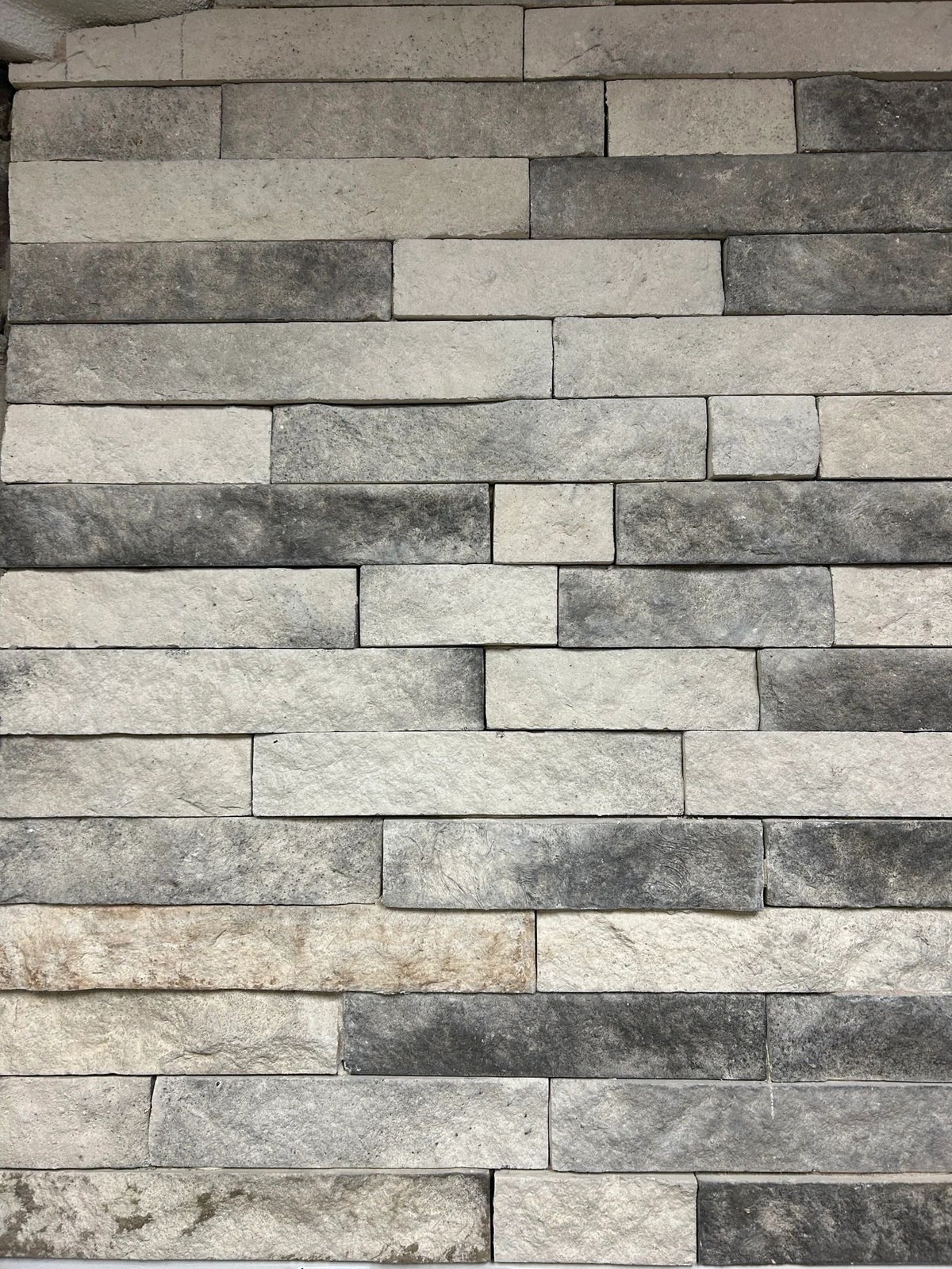 3 inch Strip Ledge manufactured stone veneer, Natural with Charcoal, installed
