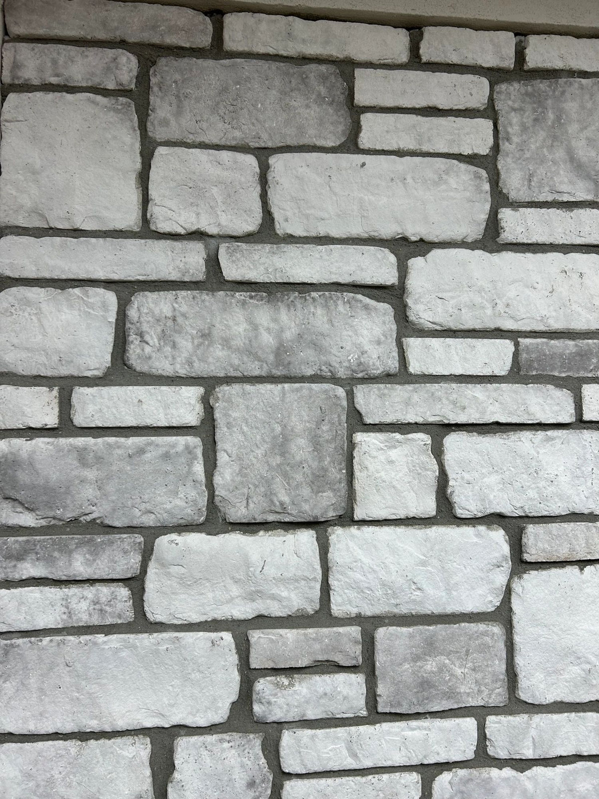 Tumbled manufactured stone veneer, Snow Silver, installed